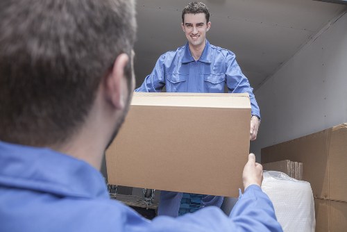 Removal team loading furniture and boxes at the start of a house move