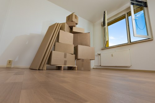 Moving team handling a house removal in Lambeth with packed boxes and furniture