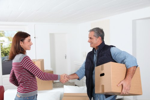 Packed boxes and furniture being loaded into a moving truck