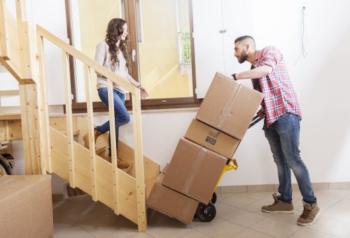Removal team navigating stairs in a Lambeth student property