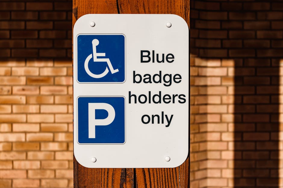 A rectangular metal sign affixed to a stone wall, displaying the message 'Parking with hotel permit only' in black uppercase letters on a white background. The sign is attached with four screws, one a